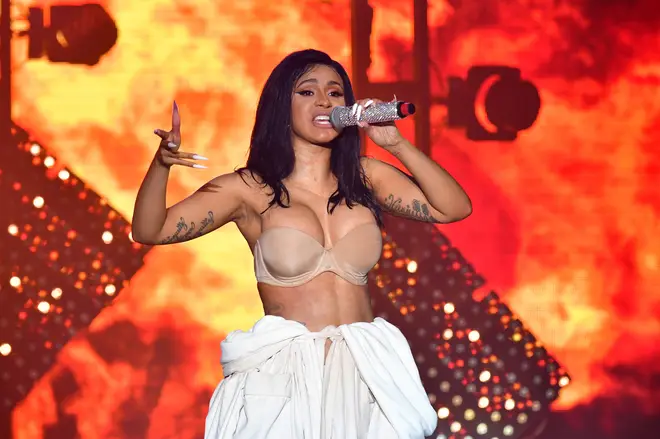 Cardi B returned to the stage wearing a white bathrobe over her underwear.