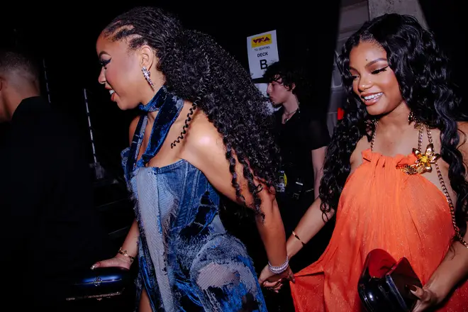 Halle Bailey (R) pictured with older sister Chloe at the 2023 VMAs.