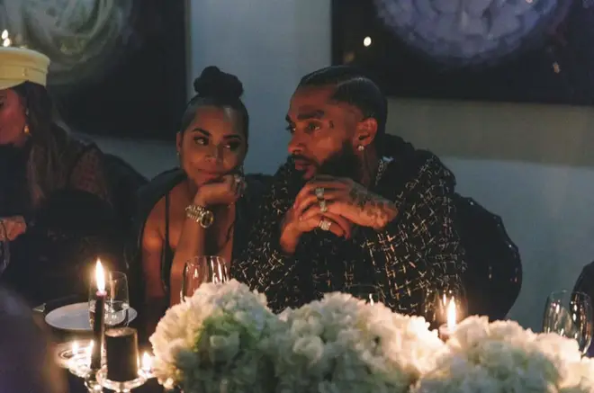 The actress, 34, gazes adoringly at Nipsey during dinner in a touching throwback picture shared by Lauren.